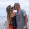 Christian Audigier et sa fiancée Nathalie Sorensen arrivent au club 55 à Ramatuelle, près de Saint-Tropez, le 8 août 2013.