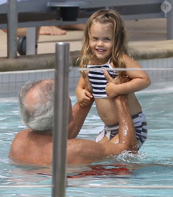 Gia, fille de Matt Damon joue avec son grand-père au bord de la piscine de l'hotel Fontainebleau à Miami, le 28 septembre 2013.