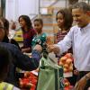 Barack Obama a distribué des colis de nourriture avec ses filles Malia et Sasha, ainsi que son épouse Michelle, dans les locaux de l'association Capital Area Food Bank à Washington, le 27 novembre 2013.