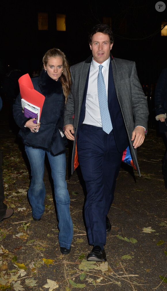 Cressida Bonas, petite amie du prince Harry, lors d'un concert de Noël le 4 décembre 2013, avec un ouvrage de puériculture à la main.