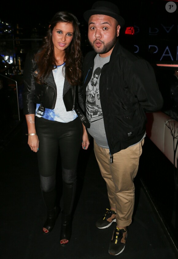 Malika Ménard et l'animateur Raphäl Yem à la soirée de lancement de la marque "Wingista" de Marion Bartoli au VIP Room à Paris, le 9 avril 2014. L'ex tennis woman s'est lancée dans la création d'accessoires pour chaussures, une collection d'ailes baptisée Wingista.