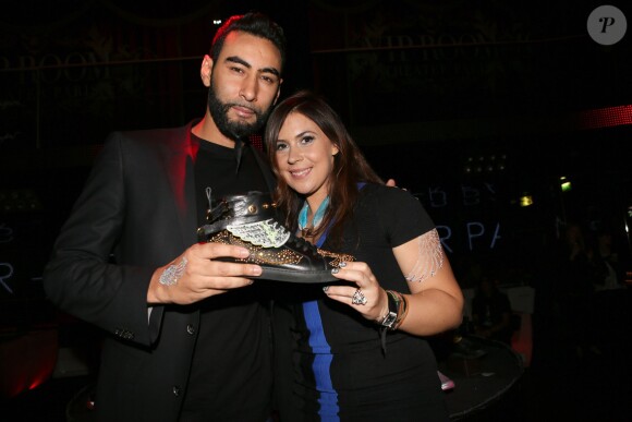 Le rappeur La Fouine et Marion Bartoli à la soirée de lancement de la marque "Wingista" de Marion Bartoli au VIP Room à Paris, le 9 avril 2014. L'ex tennis woman s'est lancée dans la création d'accessoires pour chaussures, une collection d'ailes baptisée Wingista.