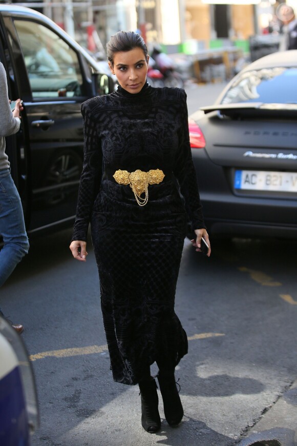 Kim Kardashian, en pleine séance shopping à Paris, porte une robe Balmain (collection automne-hiver 2012) et une ceinture Judith Lieber, des collants Kardashian Kollection et des bottines Tom Ford. Le 14 avril 2014.