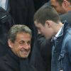 Nicolas Sarkozy et son fils Louis lors de la finale de football de la Coupe de la Ligue, PSG - Lyon (2-1), au Stade de France à Paris le 19 avril 2014. 
