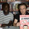 Exclusif - Le dessinateur Madd - Philippe Vandel dédicace sa bande dessinée "Les Pourquoi en BD" à la librairie BD Net à Paris, le 26 septembre 2014.