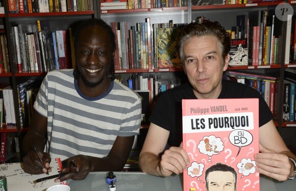 Exclusif - Le dessinateur Madd - Philippe Vandel dédicace sa bande dessinée "Les Pourquoi en BD" à la librairie BD Net à Paris, le 26 septembre 2014.