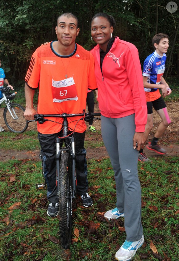 Jimmy Vicaut et Muriel Hurtis - La troisième édition de la "Run & Bike Solidaire" au profit du Secours populaire français organisée à Paris sur le Domaine national de Saint-Cloud, le 12 octobre 2014.