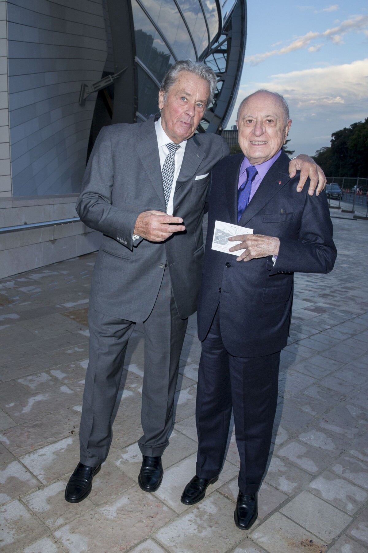 Alain Delon and Pierre Berge arriving at the Louis Vuitton art
