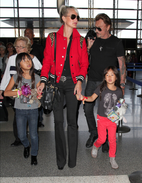 Johnny Hallyday quitte Los Angeles en famille pour rejoindre Paris le 14 octobre 2014. Le rocker était accompagné de sa femme Laeticia, de ses filles Jade et Joy, ainsi que la grand-mère de son épouse Elyette et de son chien Santos.