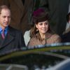 Kate Middleton, duchesse de Cambridge, entre les princes William et Harry, le 25 décembre 2014 lors du rassemblement de la famille royale pour la messe de Noël à Sandringham.