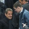 Nicolas Sarkozy et son fils Louis - People lors de la finale de football de la Coupe de la Ligue, PSG - Lyon (2-1), au Stade de France à Paris. Le 19 avril 2014.