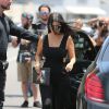 Kourtney Kardashian de sortie à West Hollywood, porte une combinaison noire Nasty Gal et des chaussures Stella McCartney. Des lunettes de soleil Fendi (collection Orchidea) et une pochette Givenchy accessoirisent sa tenue. Los Angeles, le 16 juin 2015.