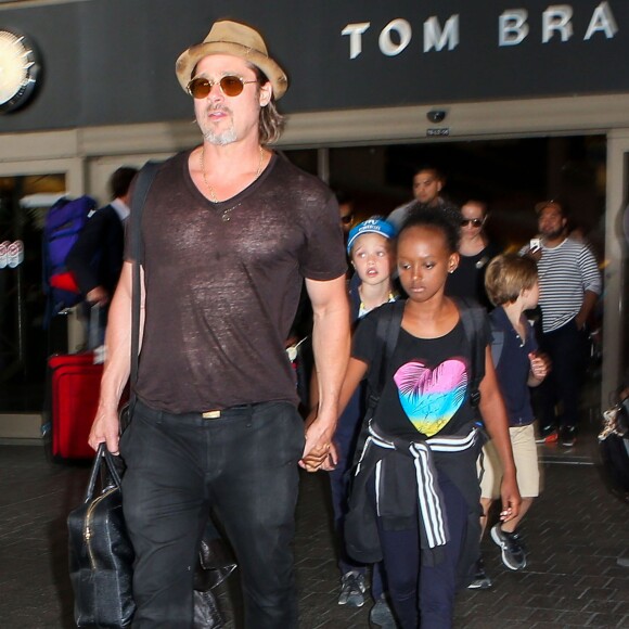 Brad Pitt avec sa fille Zahara, ses enfants Shiloh et Knox derrière lui, arrivant en famille à l'aéroport de Los Angeles le 5 juillet 2015