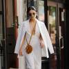 Vanessa Hudgens, tout en blanc, vêtue d'une combinaison AQ/AQ, d'une veste Asos, et d'un petit sac Chloe, le 19 mai 2015 à New York