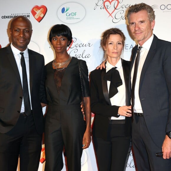 Harry Roselmack et sa femme Chrislaine, Denis Brogniart et sa femme Hortense au "Par Coeur Gala" à l'occasion des 10 ans de l'association "Cekedubonheur" au pavillon d'Armenonville à Paris le 24 septembre 2015