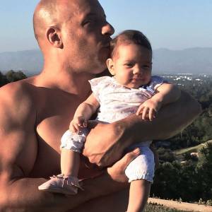 Vin Diesel pose torse nu avec son troisième enfant, Pauline. (photo postée le 13 octobre 2015)