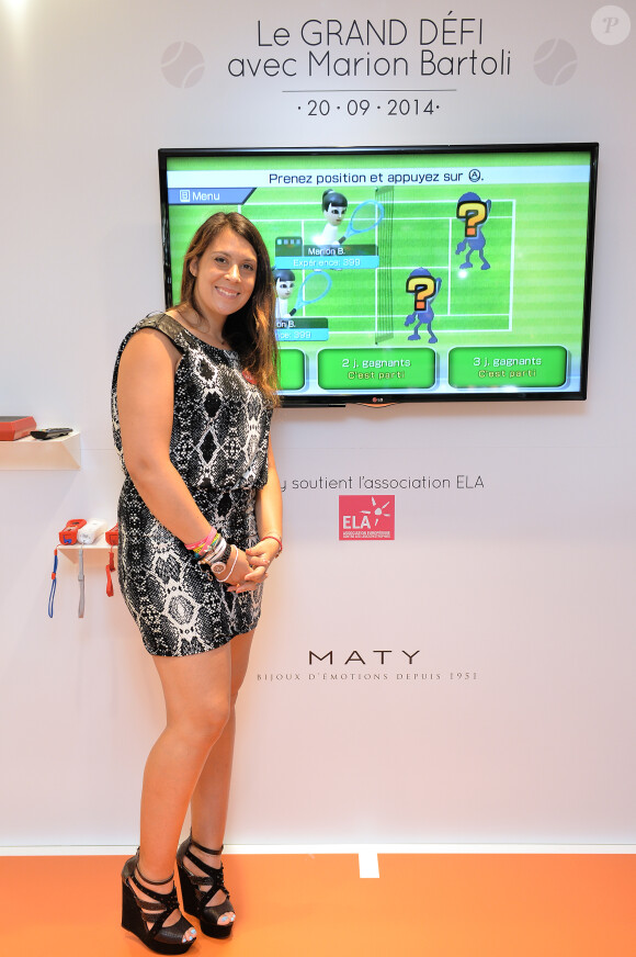Exclusif - Marion Bartoli défie ses fans à la Wii pour l'association ELA à la boutique Maty, place de l'Opéra à Paris, le 20 septembre 2014