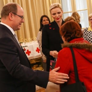 Exclusif - Le prince Albert II de Monaco et la princesse Charlene participent à la remise des cadeaux aux anciens monégasques dans les locaux de la Croix Rouge à Monaco le 16 décembre 2016.