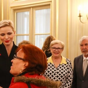 Exclusif - Le prince Albert II de Monaco et la princesse Charlene participent à la remise des cadeaux aux anciens monégasques dans les locaux de la Croix Rouge à Monaco le 16 décembre 2016.