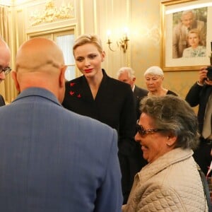 Exclusif - Le prince Albert II de Monaco et la princesse Charlene participent à la remise des cadeaux aux anciens monégasques dans les locaux de la Croix Rouge à Monaco le 16 décembre 2016.