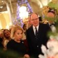 Le prince Albert II de Monaco accompagné par Louisette Levy-Soussan Azzoaglio, la présidente d'Action Innocence Monaco, pendant la traditionnelle vente aux enchères de Sapins de Noël de l'association spécialement créés et décorés pour l'occasion par de grandes marques, des boutiques et artisans de la Principauté le 14 décembre 2016 à Monaco.