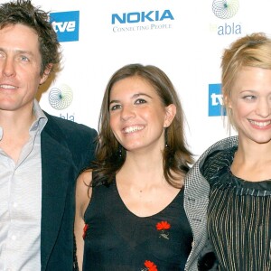 "HUGH GRANT" "LUCIA MONIZ" ET "HEIKE MAKATASCH" A LA 1ERE DU FILM "LOVE ACTUALLY" A MADRID HOMME FEMININ "PLAN SERRE" ACTEUR ACTRICE Hugh Grant, Lucia Moniz and Heike Makatsch attend the premier of "Love Actually" at the Palacio de la Musica Cinema in Madrid28/10/2003 - 