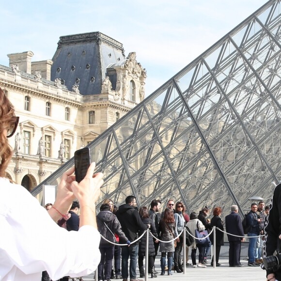 Victoria Beckham, son fils Brooklyn et le mannequin Sonia Ben Ammar devant la pyramide du Musée du Louvre à Paris. Le 11 mars 2017.