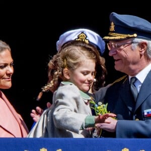 La princesse Victoria, la princesse Estelle et le roi Carl XVI Gustaf de Suède au balcon du palais royal lors de la célébration du 71e anniversaire du souverain, le 30 avril 2017 à Stockholm.