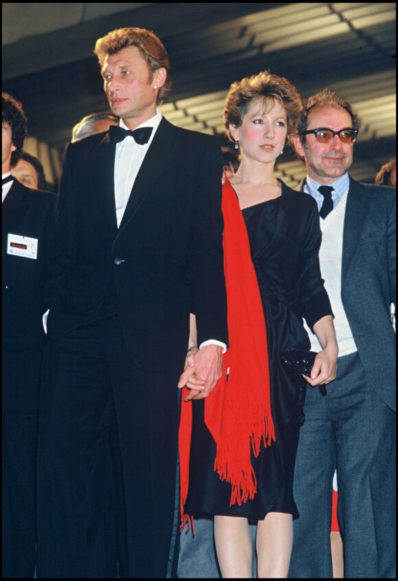 Johnny Hallyday et Nathalie Baye et Jean-Luc Godard présentent le film "Détectiveé au Festival de Cannes le 8 mai 1985.
