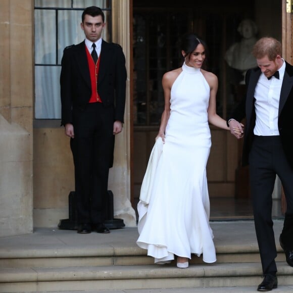 Le prince Harry, duc de Sussex, et Meghan Markle, duchesse de Sussex, habillée d'une robe Stella McCartney et portant une bague sertie d'une aigue-marine ayant appartenu à Lady Diana, ont quitté le château de Windsor après la réception offerte par Elizabeth II pour rejoindre à bord d'une Jaguar E-Type Concept Zero immatriculée "190518" Frogmore House où avait lieu la réception de leur mariage, le 19 mai 2018.