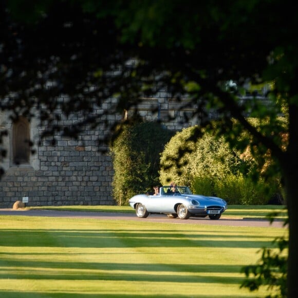 Le prince Harry, duc de Sussex, et Meghan Markle, duchesse de Sussex, habillée d'une robe Stella McCartney et portant une bague sertie d'une aigue-marine ayant appartenu à Lady Diana, ont quitté le château de Windsor après la réception offerte par Elizabeth II pour rejoindre à bord d'une Jaguar E-Type Concept Zero immatriculée "190518" Frogmore House où avait lieu la réception de leur mariage, le 19 mai 2018.