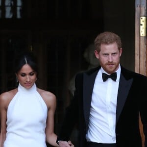 Le prince Harry, duc de Sussex, et Meghan Markle, duchesse de Sussex, habillée d'une robe Stella McCartney et portant une bague sertie d'une aigue-marine ayant appartenu à Lady Diana, quittant le château de Windsor après la réception offerte par Elizabeth II pour rejoindre à bord d'une Jaguar E-Type Concept Zero immatriculée "190518" Frogmore House où avait lieu la réception de leur mariage, le 19 mai 2018.