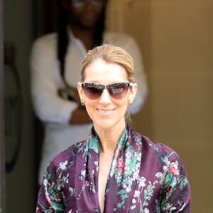 Céline Dion salue ses fans à la sortie de l'hôtel Royal Monceau à Paris le 5 juillet 2017. Elle porte un sac Gucci embarqué dans ses valises pour sa tournée été 2018.