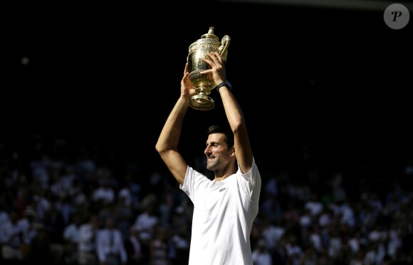Novak Djokovic with the trophy after winning the Gentlemen's Singles Final against Kevin Anderson on day thirteen of the Wimbledon Championships at the All England Lawn Tennis and Croquet Club, Wimbledon. PRESS ASSOCIATION Photo. Picture date: Sunday July 15, 2018. See PA story TENNIS Wimbledon. Photo credit should read: Tim Ireland/PA Wire. RESTRICTIONS: Editorial use only. No commercial use without prior written consent of the AELTC. Still image use only - no moving images to emulate broadcast. No superimposing or removal of sponsor/ad logos. Call +44 (0)1158 447447 for further information. ... Wimbledon 2018 - Day Thirteen - The All England Lawn Tennis and Croquet Club ... 15-07-2018 ... London ... UK ... Photo credit should read: Tim Ireland/PA Wire. Unique Reference No. 37586084 ...15/07/2018 - 