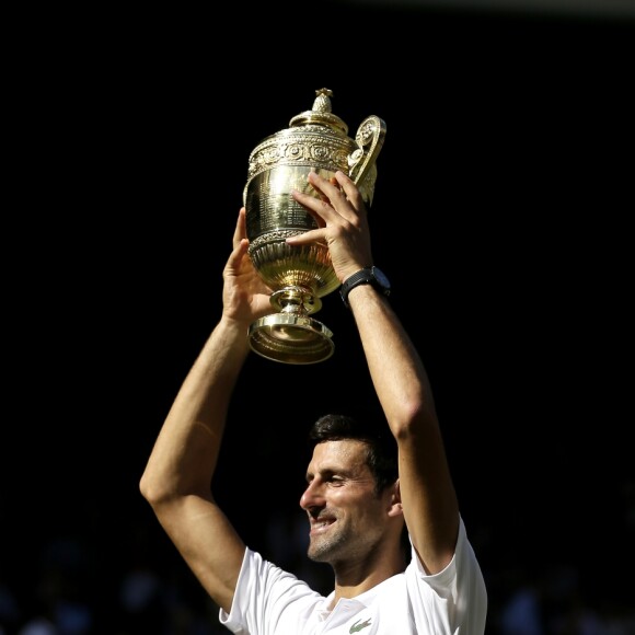 Novak Djokovic with the trophy after winning the Gentlemen's Singles Final against Kevin Anderson on day thirteen of the Wimbledon Championships at the All England Lawn Tennis and Croquet Club, Wimbledon. PRESS ASSOCIATION Photo. Picture date: Sunday July 15, 2018. See PA story TENNIS Wimbledon. Photo credit should read: Tim Ireland/PA Wire. RESTRICTIONS: Editorial use only. No commercial use without prior written consent of the AELTC. Still image use only - no moving images to emulate broadcast. No superimposing or removal of sponsor/ad logos. Call +44 (0)1158 447447 for further information. ... Wimbledon 2018 - Day Thirteen - The All England Lawn Tennis and Croquet Club ... 15-07-2018 ... London ... UK ... Photo credit should read: Tim Ireland/PA Wire. Unique Reference No. 37586084 ...15/07/2018 - 