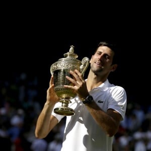 Novak Djokovic with the trophy after winning the Gentlemen's Singles Final against Kevin Anderson on day thirteen of the Wimbledon Championships at the All England Lawn Tennis and Croquet Club, Wimbledon. PRESS ASSOCIATION Photo. Picture date: Sunday July 15, 2018. See PA story TENNIS Wimbledon. Photo credit should read: Tim Ireland/PA Wire. RESTRICTIONS: Editorial use only. No commercial use without prior written consent of the AELTC. Still image use only - no moving images to emulate broadcast. No superimposing or removal of sponsor/ad logos. Call +44 (0)1158 447447 for further information. ... Wimbledon 2018 - Day Thirteen - The All England Lawn Tennis and Croquet Club ... 15-07-2018 ... London ... UK ... Photo credit should read: Tim Ireland/PA Wire. Unique Reference No. 37586077 ...15/07/2018 - 