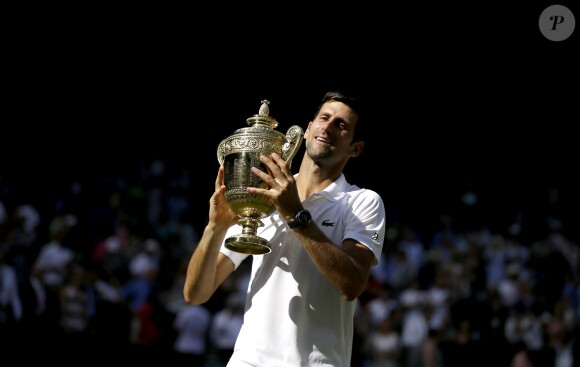 Novak Djokovic with the trophy after winning the Gentlemen's Singles Final against Kevin Anderson on day thirteen of the Wimbledon Championships at the All England Lawn Tennis and Croquet Club, Wimbledon. PRESS ASSOCIATION Photo. Picture date: Sunday July 15, 2018. See PA story TENNIS Wimbledon. Photo credit should read: Tim Ireland/PA Wire. RESTRICTIONS: Editorial use only. No commercial use without prior written consent of the AELTC. Still image use only - no moving images to emulate broadcast. No superimposing or removal of sponsor/ad logos. Call +44 (0)1158 447447 for further information. ... Wimbledon 2018 - Day Thirteen - The All England Lawn Tennis and Croquet Club ... 15-07-2018 ... London ... UK ... Photo credit should read: Tim Ireland/PA Wire. Unique Reference No. 37586077 ...15/07/2018 - 