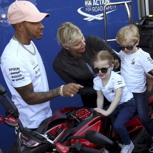 Exclusif - La princesse Gabriella et le prince Jacques de Monaco sur une moto sous les yeux de Lewis Hamilton et de leurs parents le prince Albert II et la princesse Charlene de Monaco lors de leur visite du paddock du Grand Prix de Formule 1 de Monaco le 25 mai 2018