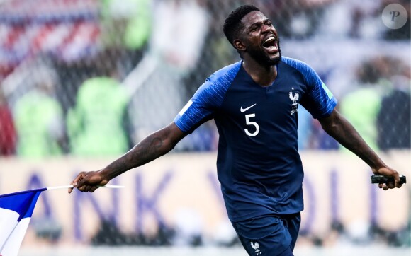 MOSCOW, RUSSIA - JULY 15, 2018: France's Samuel Umtiti waves a French flag as he celebrates victory in the 2018 FIFA World Cup Final match between France and Croatia at Luzhniki Stadium.