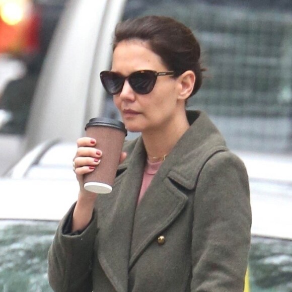 Katie Holmes porte un long manteau en laine kaki, des lunettes de soleil, une paire de Uggs marrons et un pantalon ample alors qu'elle regagne son domicile avec un café à emporter. New York, le 18 avril 2019. Actress, Katie Holmes looks cozy and low-key in her beige coat and UGGs with some trendy shades. Kate attempts to get some pep in her step by her sipping coffee during her early morning errands. New York, April 18th 2019.18/04/2019 - New York