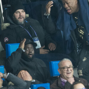 Issa Doumbia et Mokobé assistent au match Paris Saint-Germain - Lille pour la 14e journée du championnat de Ligue 1 Conforama, au Parc des Princes. Paris, le 22 novembre 2019.