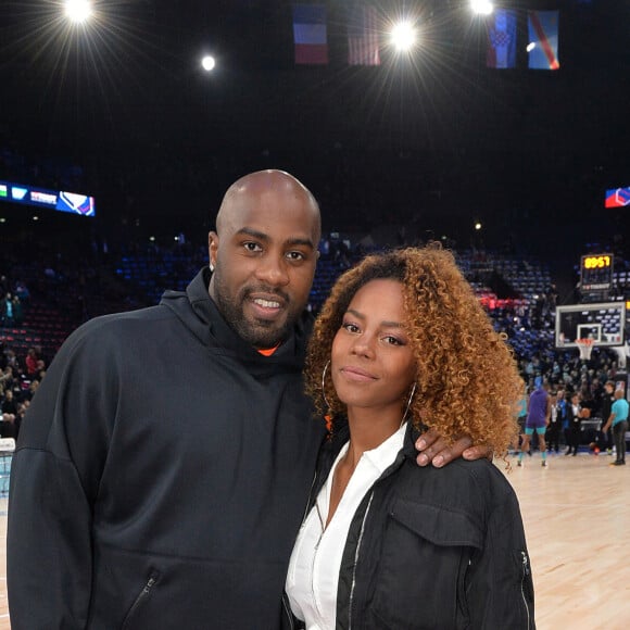 Teddy Riner et sa compagne Luthna Plocus assistent au NBA Game Paris 2020 opposant les Milwaukee Bucks et les Charlotte Hornets à l'AccorHotels Arena. Paris, le 24 janvier 2020. © Veeren / Bestimage