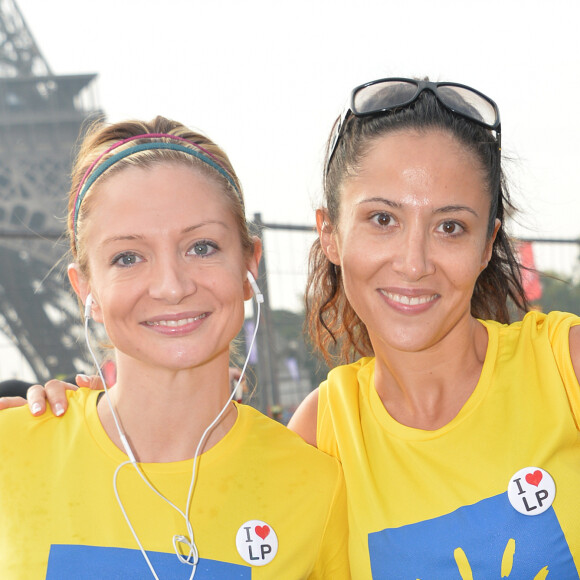 Fabienne Carat et sa soeur Carole - Course "La Parisienne 2014" pour la lutte contre le cancer, au Champs de Mars à Paris, le 14 septembre 2014.