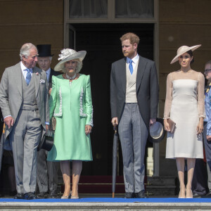 Camilla Parker Bowles, duchesse de Cornouailles, le prince Harry, duc de Sussex, et Meghan Markle, duchesse de Sussex, lors de la garden party pour les 70 ans du prince Charles au palais de Buckingham à Londres. Le 22 mai 2018