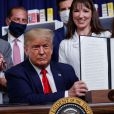 Le président des États-Unis, Donald Trump montre un décret sur la réduction des prix des médicaments lors d'une cérémonie à Washington le 24 juillet 2020.