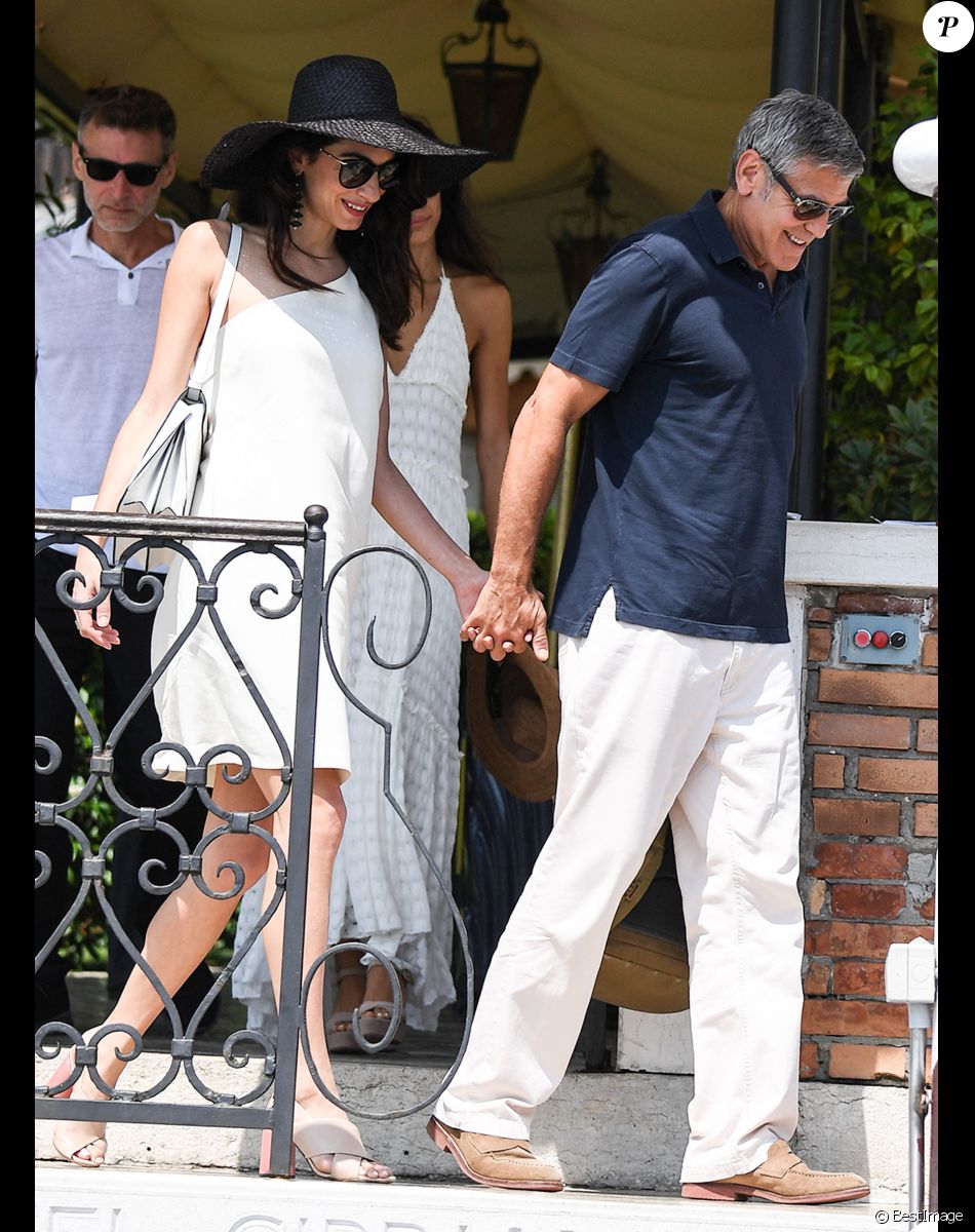 George Clooney et sa femme Amal Clooney sortent de leur hôtel, et prennent un bateau taxi pour se rendre dans un héliport pour s'envoler en hélicoptère de Venise, Italie, le 27 juin 2019.