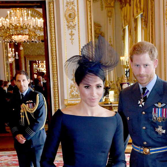 Le prince Harry, duc de Sussex et Meghan Markle, duchesse de Sussex (habillée en Dior Haute Couture par Maria Grazia Chiuri) - La famille royale d'Angleterre à la réception du 100ème anniversaire de la RAF au palais de Buckingham à Londres. Le 10 juillet 2018 