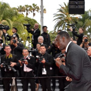 Omar Sy à la montée des marches de "Top Gun : Maverick" lors du 75ème Festival International du Film de Cannes, le 18 mai 2022. 