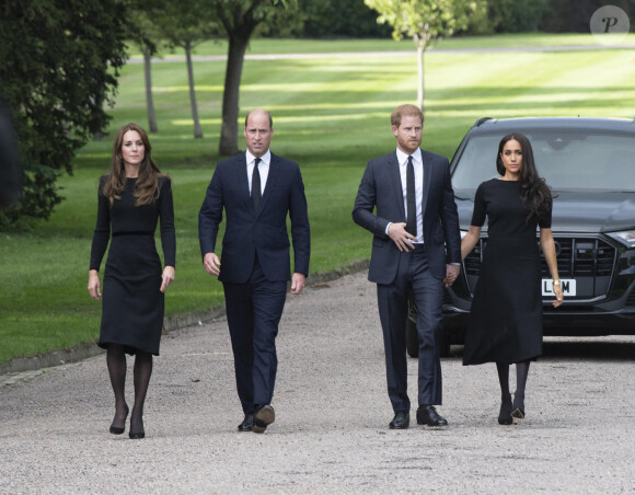 Catherine, Princess of Wales, Prince William, Prince of Wales, Prince Harry, Duke of Sussex, and Meghan, Duchess of Sussex on the long Walk at Windsor Castle arrive to view flowers and tributes to HM Queen Elizabeth on September 10, 2022 in Windsor, England. Crowds have gathered and tributes left at the gates of Windsor Castle to Queen Elizabeth II, who died at Balmoral Castle on 8 September, 2022.