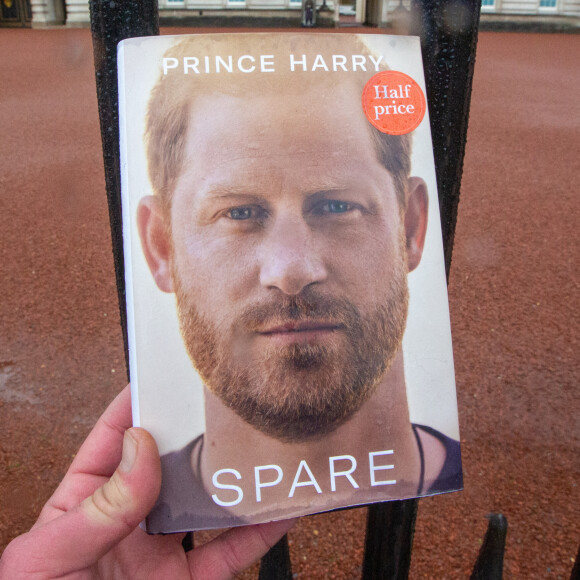 Un exemplaire du livre "Spare" du prince Harry avec en arrière plan le palais de Buckingham, à Londres, au Royaume-Uni, le 10 janvier 2023. 
